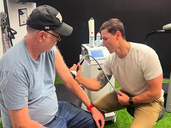 StemWave shockwave therapy on a patient's forearm at Full Swing Healthcare in Jacksonville, FL